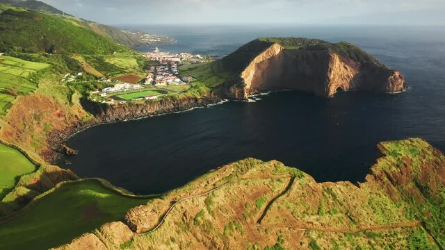 Sao Jorge, Azores, Portugal. Iconic vista with the sharp coastline, beautiful ocean and countryside town. Aerial footage of the volcanic peninsula with lush endemic vegetation. High quality 4k footage