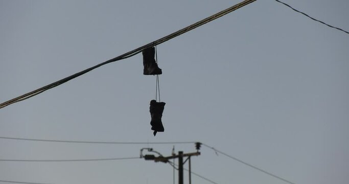 Shoes hanging off of power lines