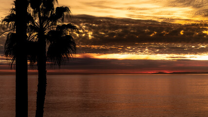 Fototapeta na wymiar Orange sunset at a beach