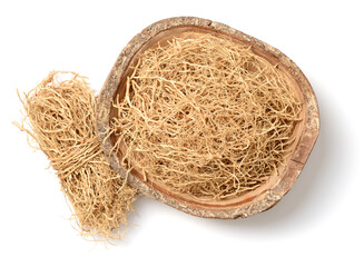 dried vetiver roots in the wooden bowl, isolated on the white background, top view