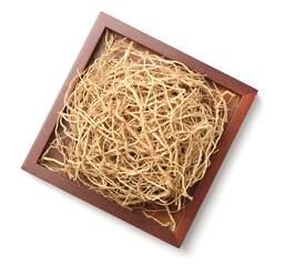 dried vetiver roots in the wooden plate, isolated on the white background, top view