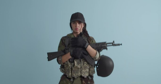 Running female soldier with assault rifle on color background
