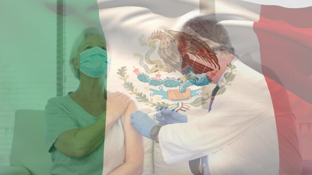 Animation of flag of mexico waving over doctor wearing face mask and vaccinating senior woman
