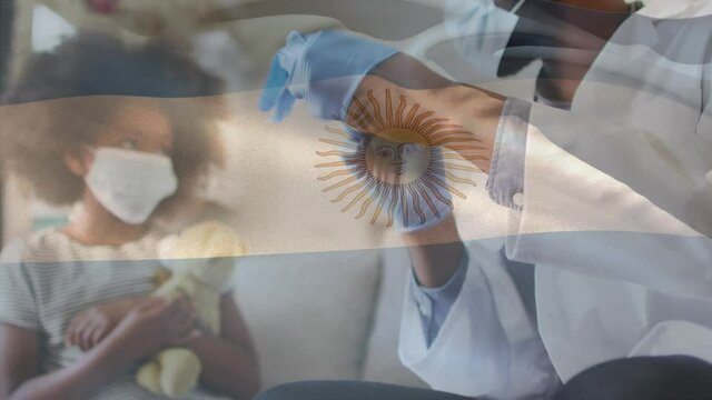 Animation of flag of argentina waving over doctor wearing face mask and vaccinating child