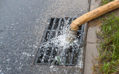 Draining water through a flexible hose into the sewer