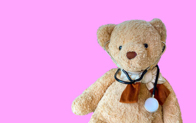 cute teddy bear with  stethoscope on pink background with copy space,   Concept of health care and wellbeing ,  life insurance concept,