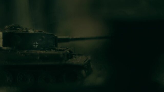 Toy tanks staging battle in ruined city with smoke effects. Macro view of T34 and Panther tanks. Models of famous tanks from WWII: Panther and T34