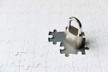 Selective focus of an empty space of jigsaw puzzle fill with padlock.