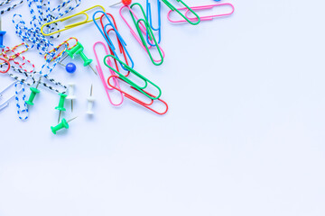 Lots of colorful paper wires scattered on a white background.
