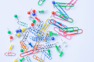 Lots of colorful paper wires scattered on a white background.