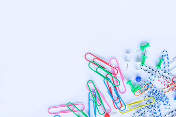 Lots of colorful paper wires scattered on a white background.