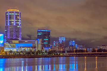 The business quarter of the city on the river bank on a late autumn evening