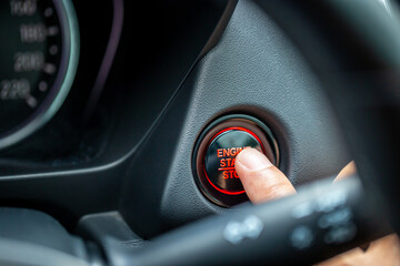 Finger push the engine start / stop modern car button