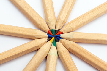Many different colored pencils.Color pencils in arrange in color wheel colors on white background.