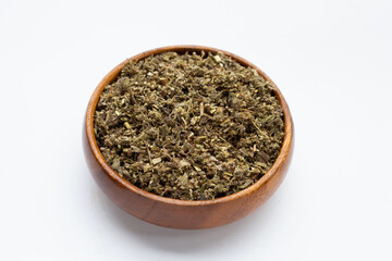 Dried absinthe wormwood in wooden bowl on white background.