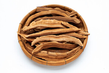 Dried lingzhi mushroom slices in bamboo basket on white background