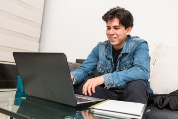 video call with friends in process. young man in virtual classes from his laptop. student in virtual classroom