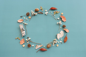 Top view image of autumn forest natural composition over blue background .Flat lay