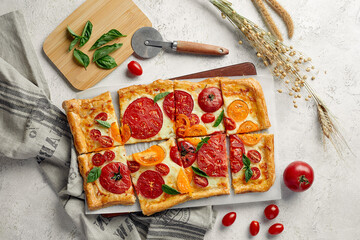 Delicious homemade square pizza with vegetables on white