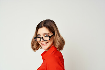 Fototapeta premium Business woman in red shirt and glasses manager work light background