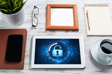 Web security and technology concept with tablet pc on wooden table