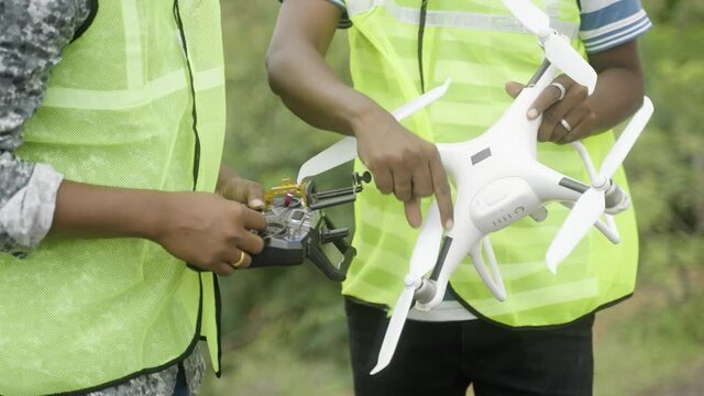 close up hands of Unrecognizable Trainer teaching by explaining about drone operations to student - Concept drone or UAV pilot training.