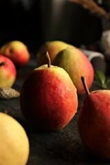 sweet and fragrant autumn pears on rustic black wooden table