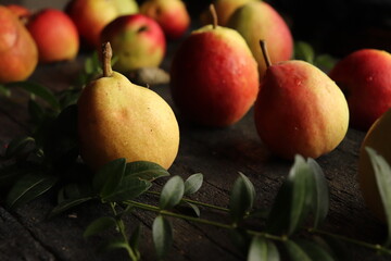 sweet and fragrant autumn pears on rustic black wooden table