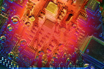 Hot red spot on blue circuit board abstract background texture. 