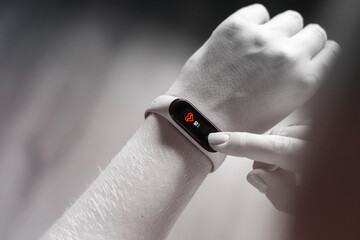 young woman workout in gym and measuring her heart rate on smart watch close up