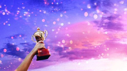 Champions golden trophy that is raised by the person who won the competition. Success and...