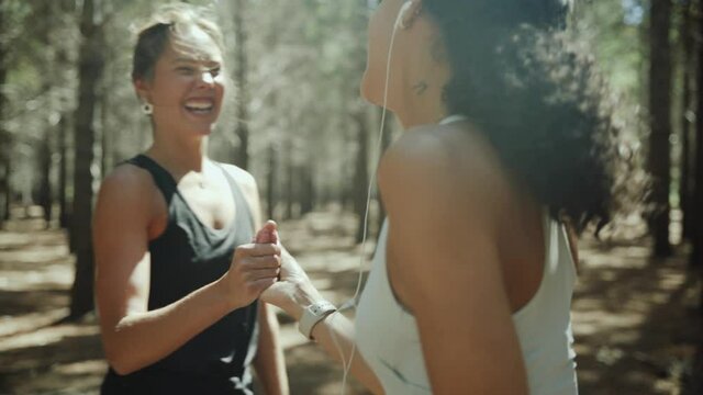 Mixed race female teenager friends exercising in forest setting