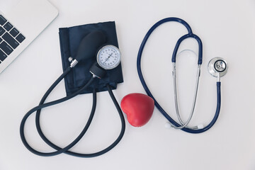Top view of stethoscope with Sphygmomanometer; Aneroid manual blood pressure gauge and laptop....