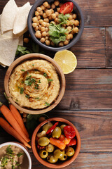 bowl of hummus with pita bread and snack