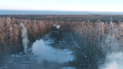 Aerial view of construction site in winter forest. 