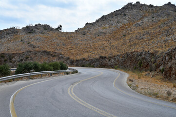 Highway road in the mountains, rocks on both sides
