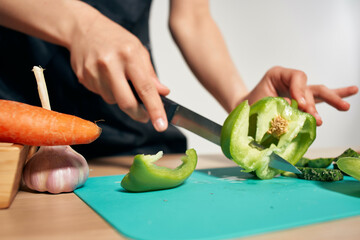 Obraz na płótnie Canvas housewife cutting vegetables healthy eating salad ingredients