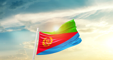 Eritrea national flag cloth fabric waving on beautiful sky - Image