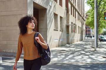 Cute black girl crossing a street outdoors