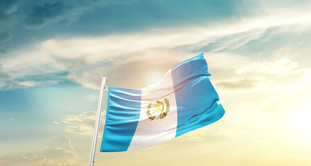 Guatemala national flag cloth fabric waving on beautiful sky - Image