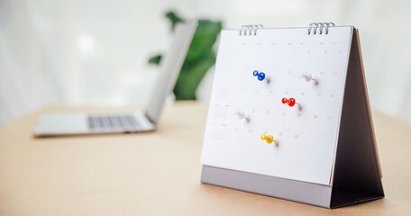 Calendar desk place on the table. Desktop Calender for Planner to plan agenda, timetable, appointment, organization, management each date, month, and year on wooden office table. Calendar Concept.