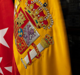 Detail of the Spanish flag fabric with embroidered coat of arms.