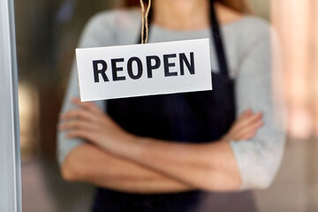 small business, reopening and service concept - reopen banner on window or door glass and waitress