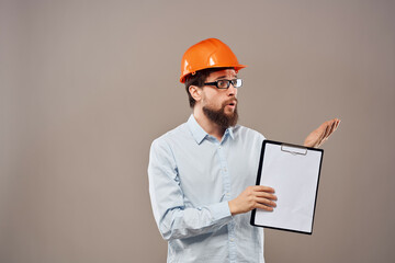 surprised man documents in hand and drawings protective uniform