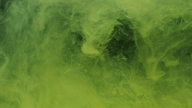 Yellow ink acrylic paint mixing in water, swirling softly underwater. Colored citric acrylic cloud of paint in aquarium. Slow motion abstract smoke explosion animation. Beautiful art background