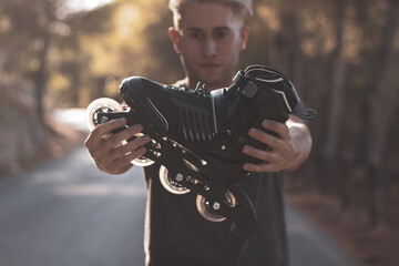 a gay boy riding on in-line skates skating on a road.