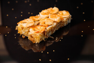 sushi with shrimps on a black mirror background
