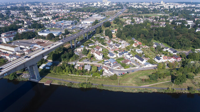 CAEN, FRANCE-SEPTEMBER 2021: Viaduc de Calix on the canal de caen. The largest bridge in Caen, an important road E46 for cars. A photo from the drone, in the phone is buildings and greenery