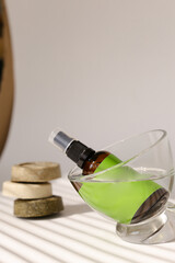 Spray bottle in glass with green space for brand and solid bars of soap.