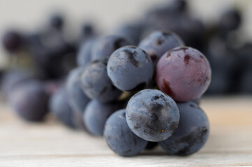 Bunch of fresh grapes on a light background closeup. Shallow depth of field